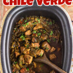 Overhead view of a slow cooker filled with pork chile verde with a title text overlay for Pinterest.