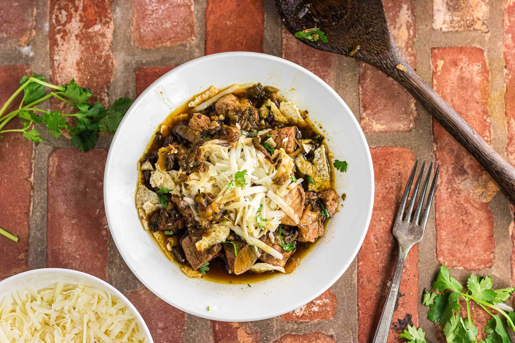 Overhead view of pork chile verde in a white bowl