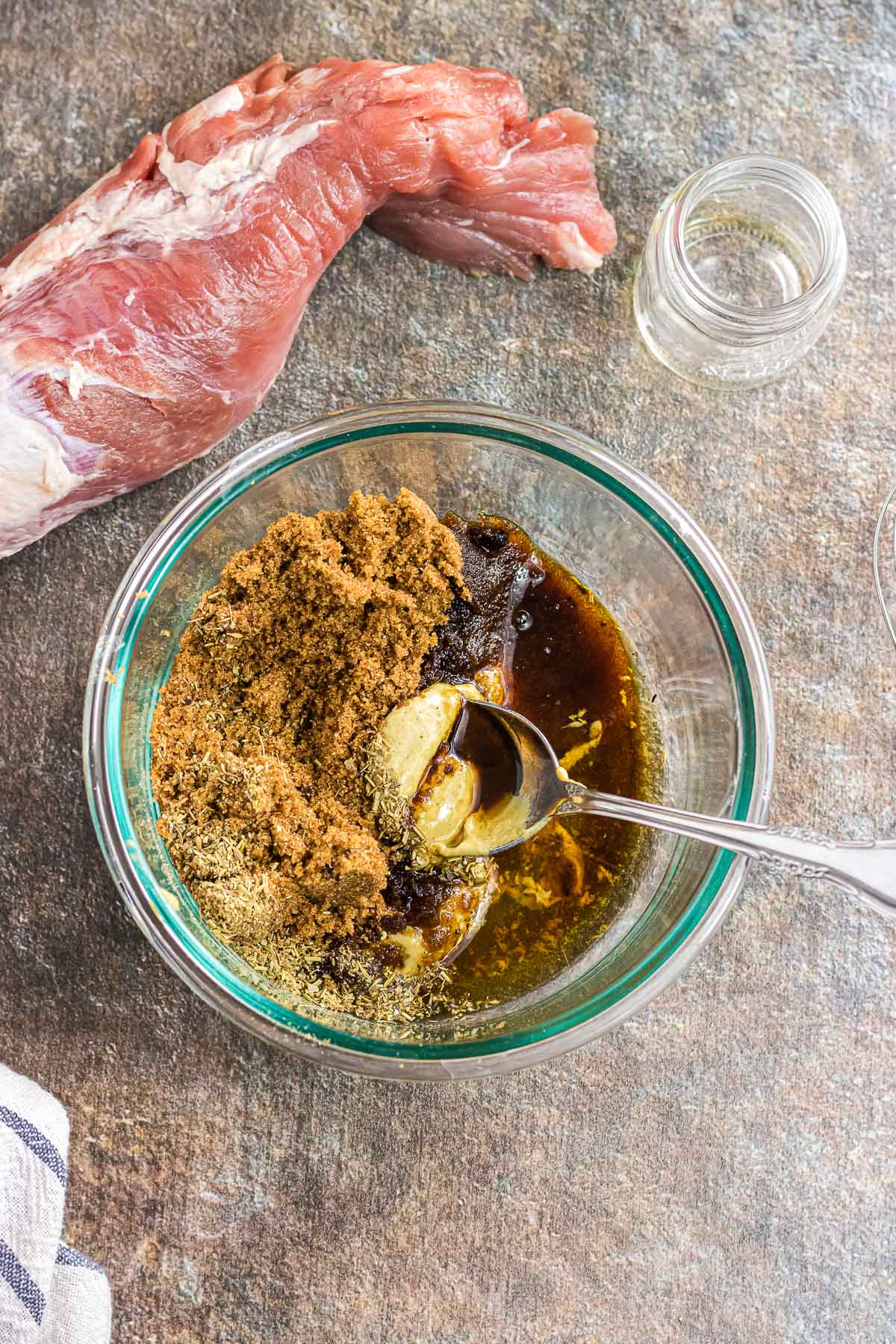 Stirring the sugar, mustard, garlic, and bourbon together.