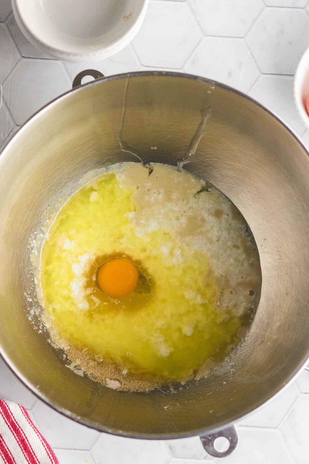 Buttermilk and yeast mixture in the bowl of an electric mixer.