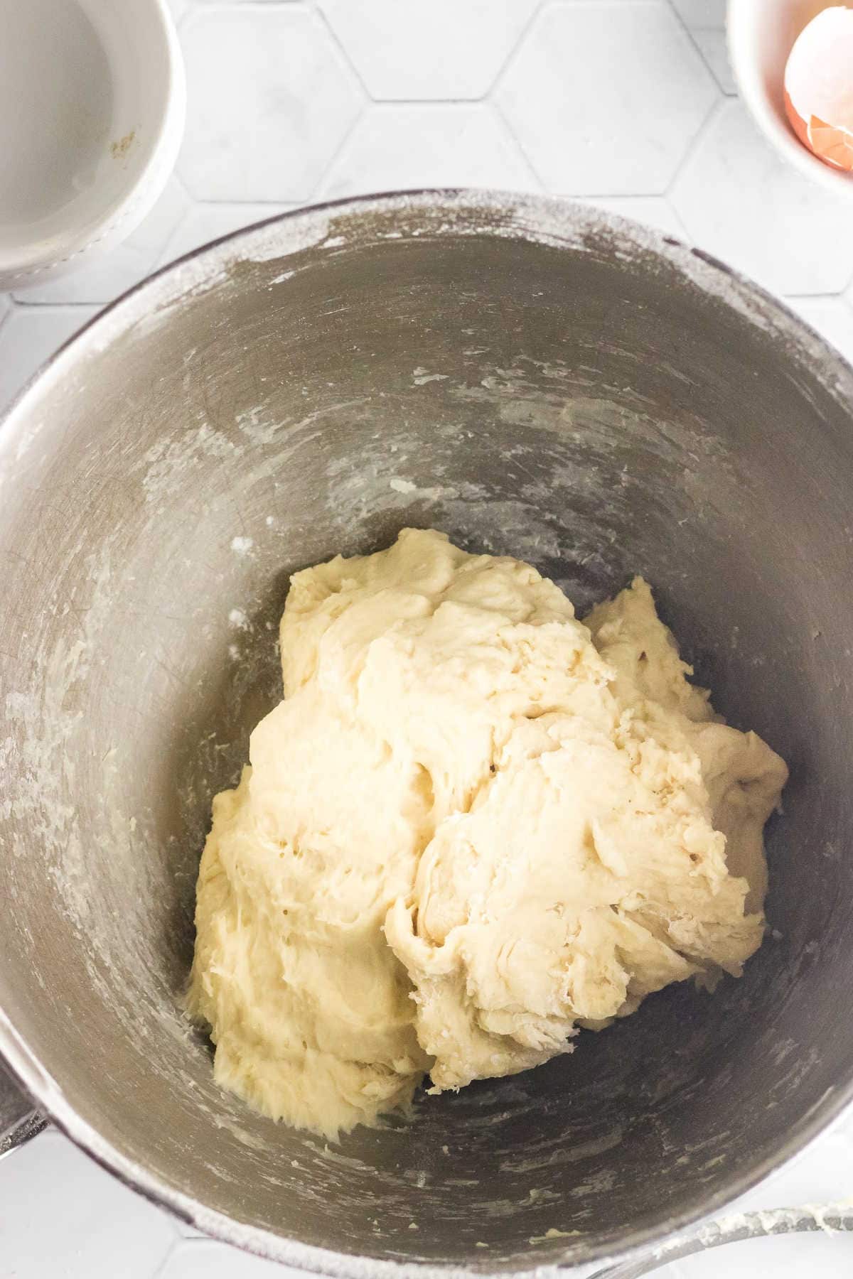 The kneaded dough in the bowl of the mixer.