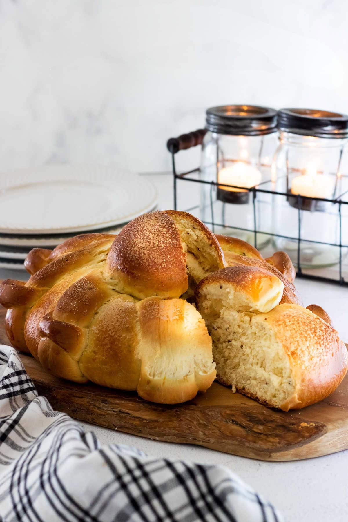 A loaf of Pan de Muerto that has been sliced into.