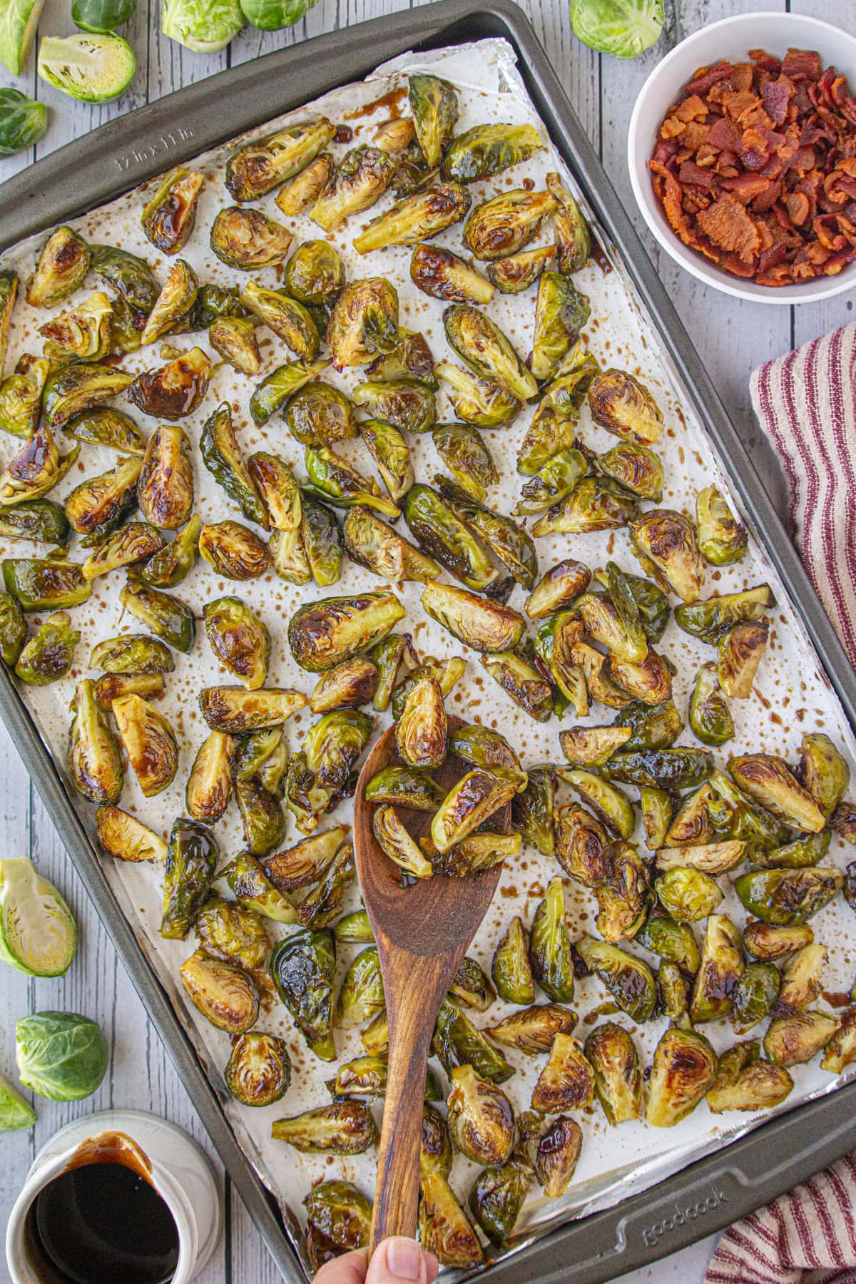 Stirring the Brussels sprouts to cover them in the dressing.