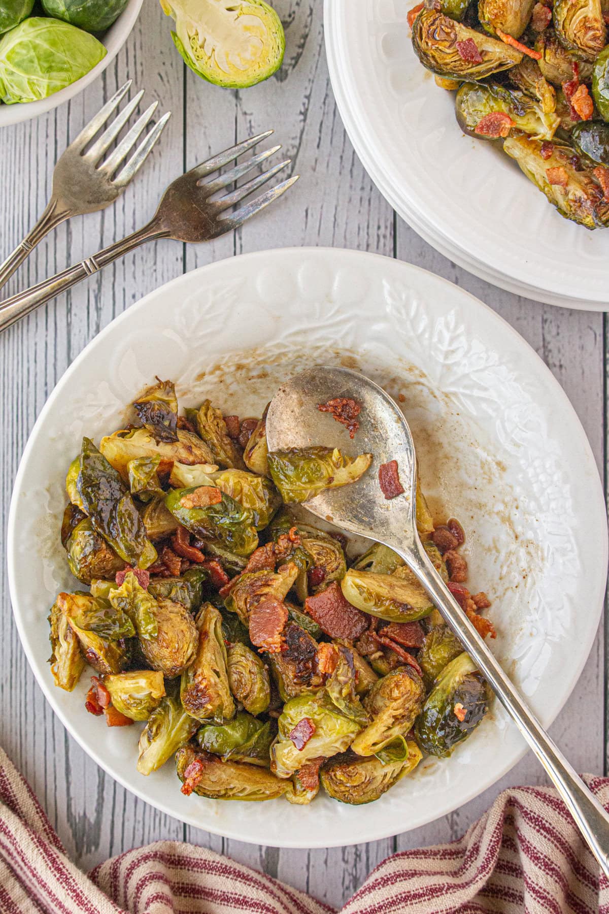 An overhead photo of Brussels sprouts with hot bacon dressing in a serving bowl.