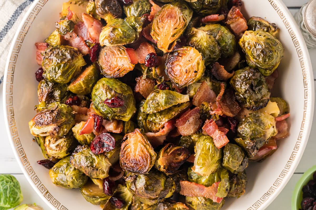 Overhead view of maple roasted brussels sprouts with bacon and cranberries.