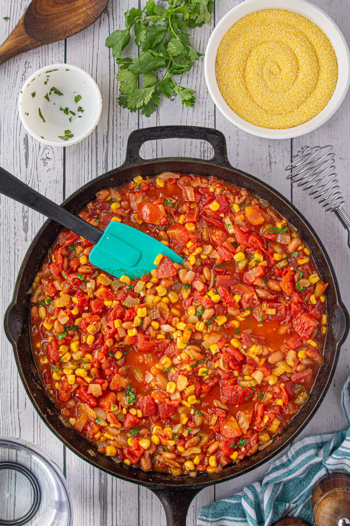 Corn, tomatoes, and onion mixture stirred up.