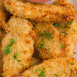 Crispy air fryer chicken tenders on a plate with a title text overlay for Pinterest.