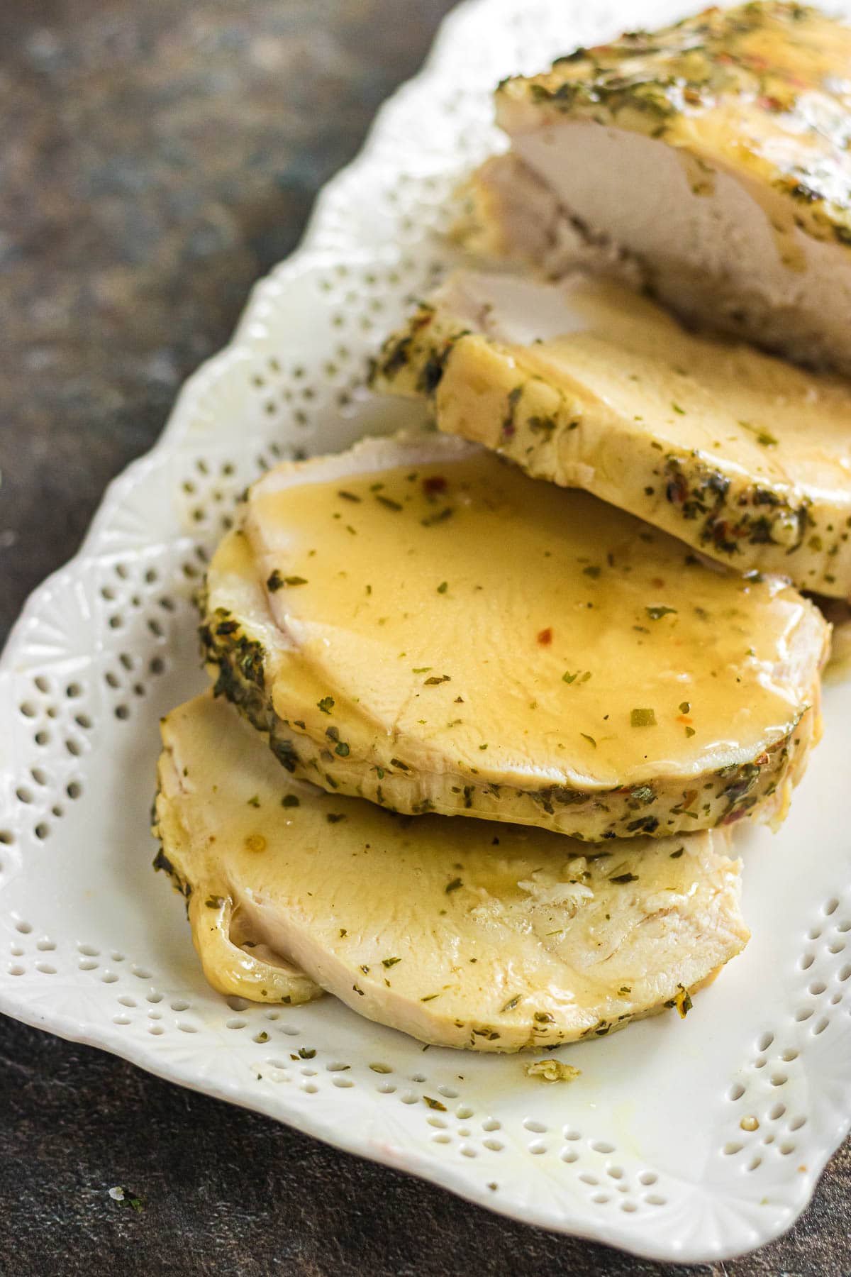 Sliced slow cooker boneless turkey breast on a serving platter.