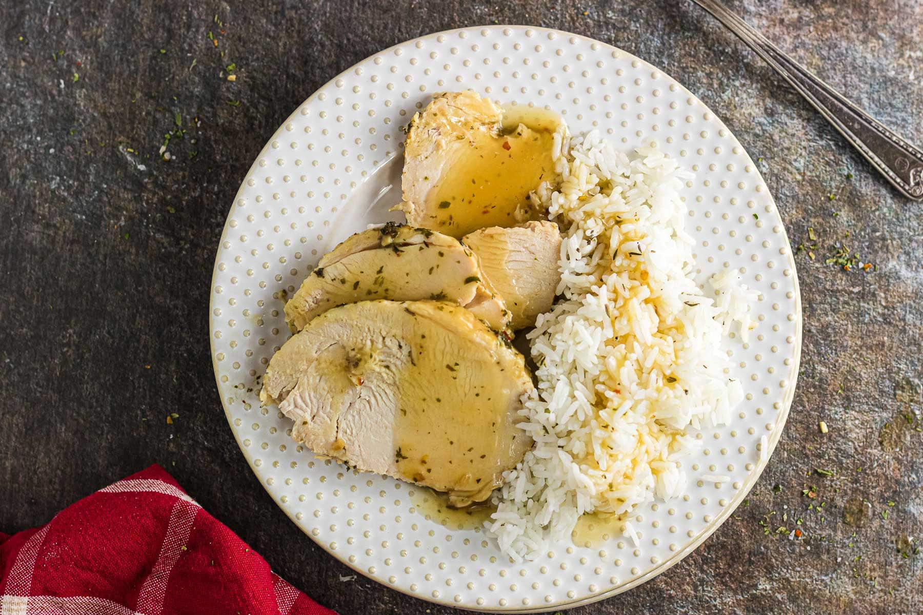 Overhead view of turkey breast slices on a plate.