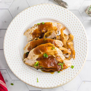 Overhead view of a plate with sliced turkey breast on it.