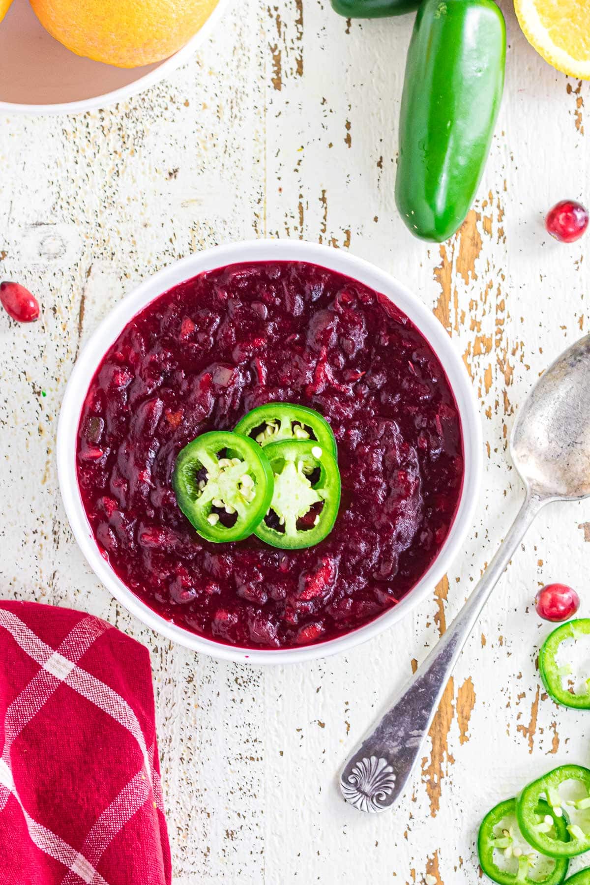 Overhead view of cranberry sauce in a white bowl.