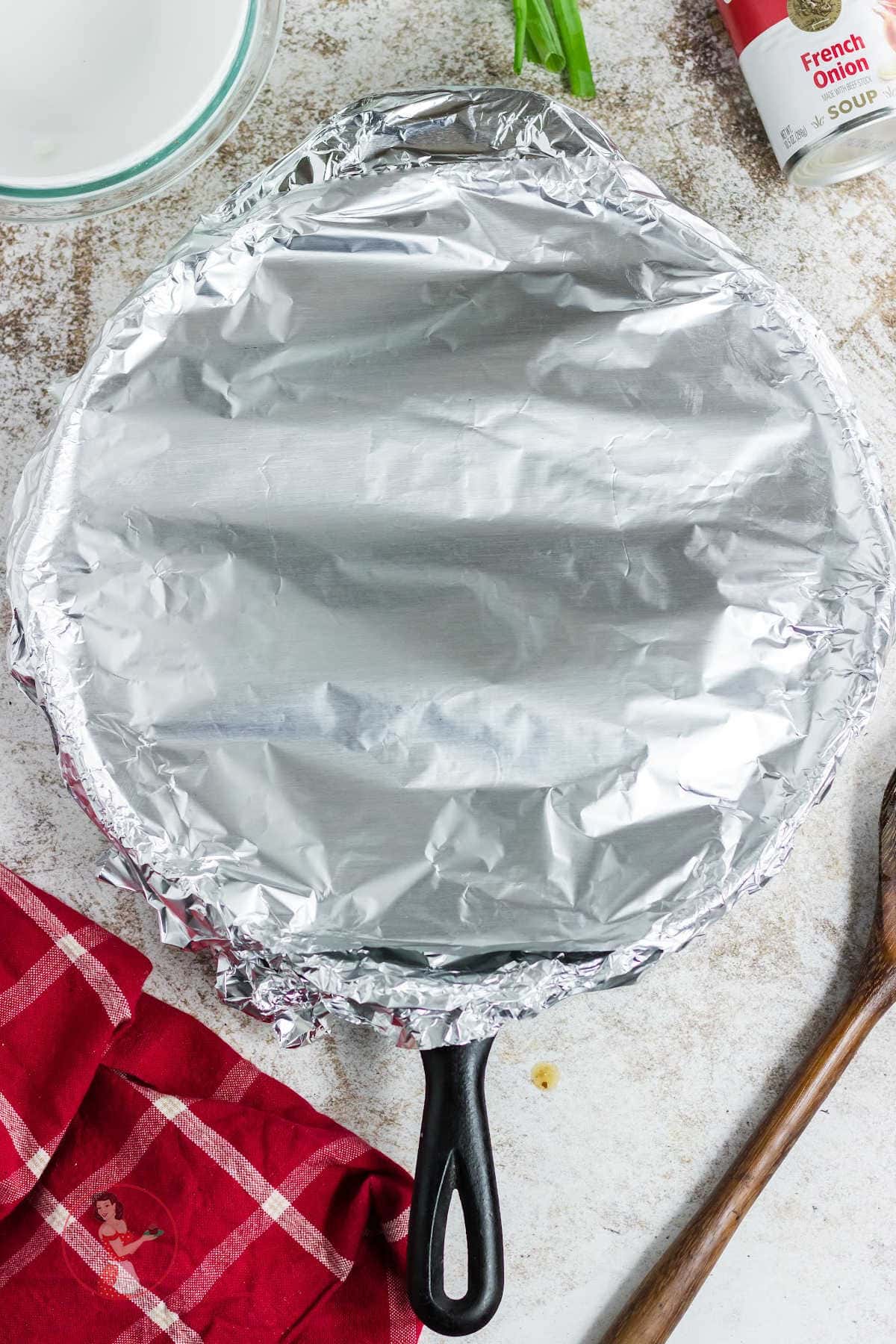 The skillet (ovenproof) is covered with aluminum foil.