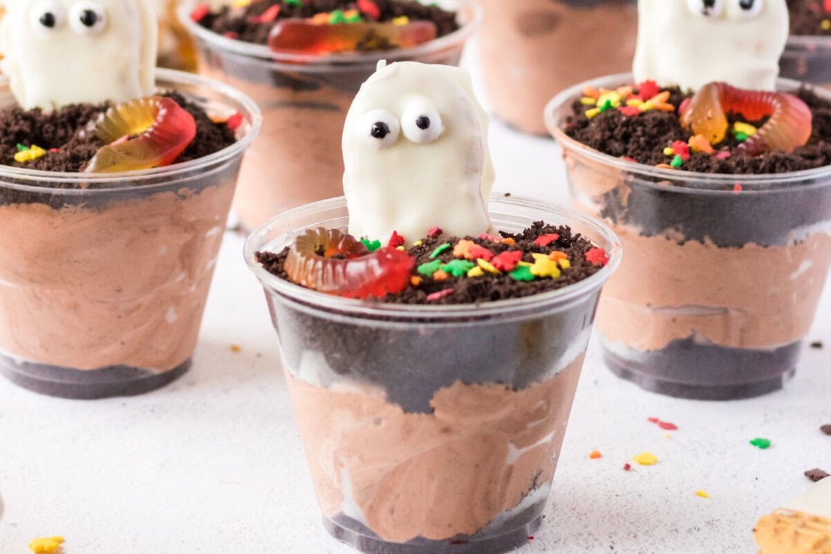 Halloween dirt cups with chocolate pudding, Oreos, and Nutter Butter ghosts.