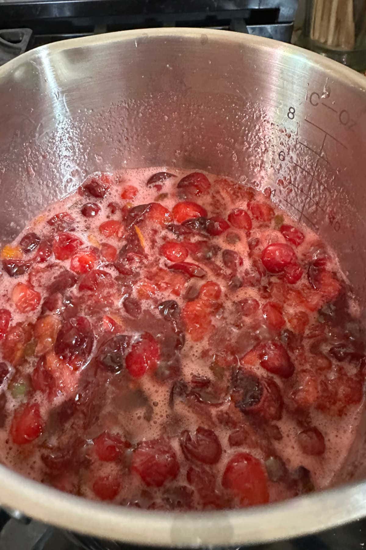 Simmering the cranberries in the sauce pan.