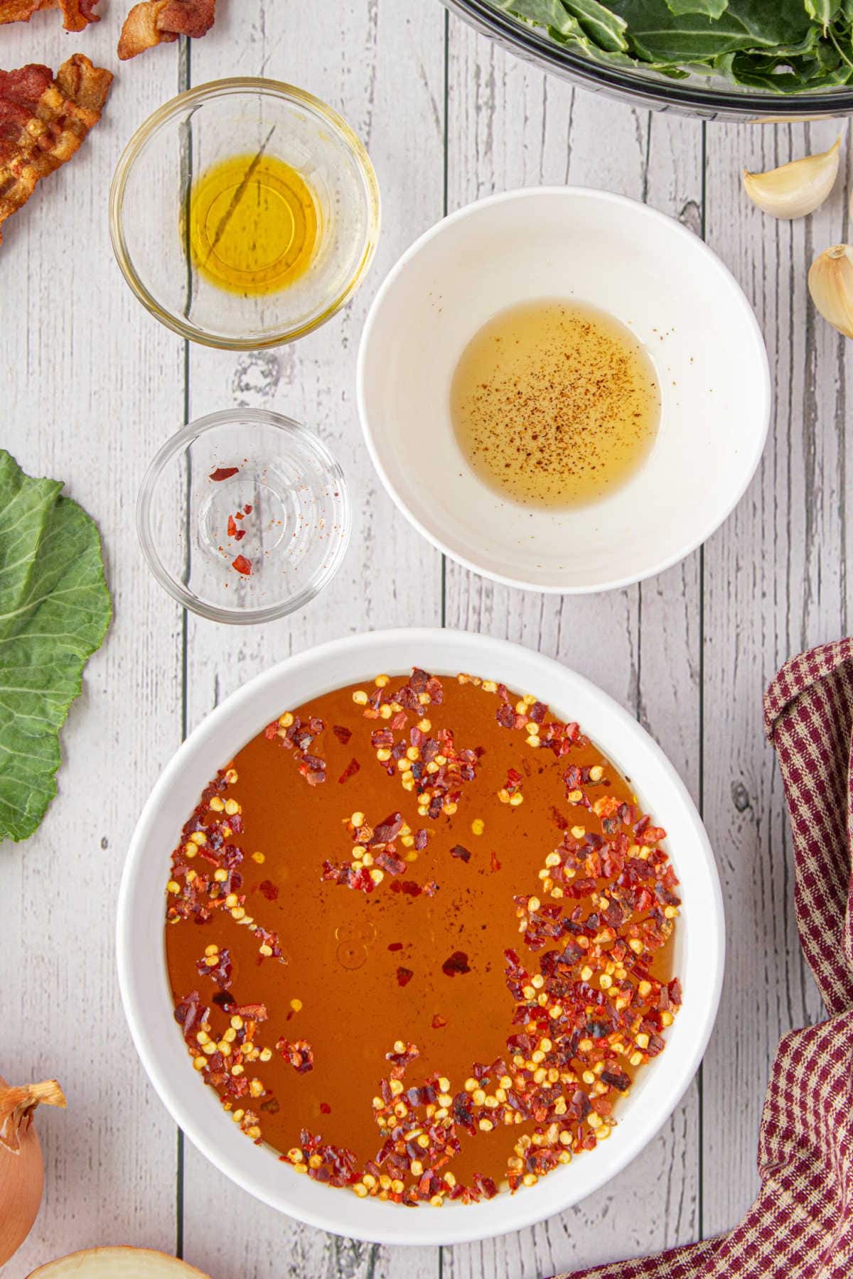 A mixture of seasonings, chicken stock, and bacon drippings to cook the collard greens in.