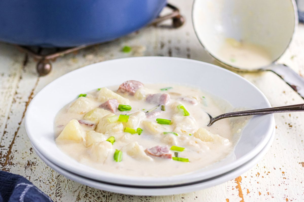 A closeup of a bowl of potato smoked sausage soup.