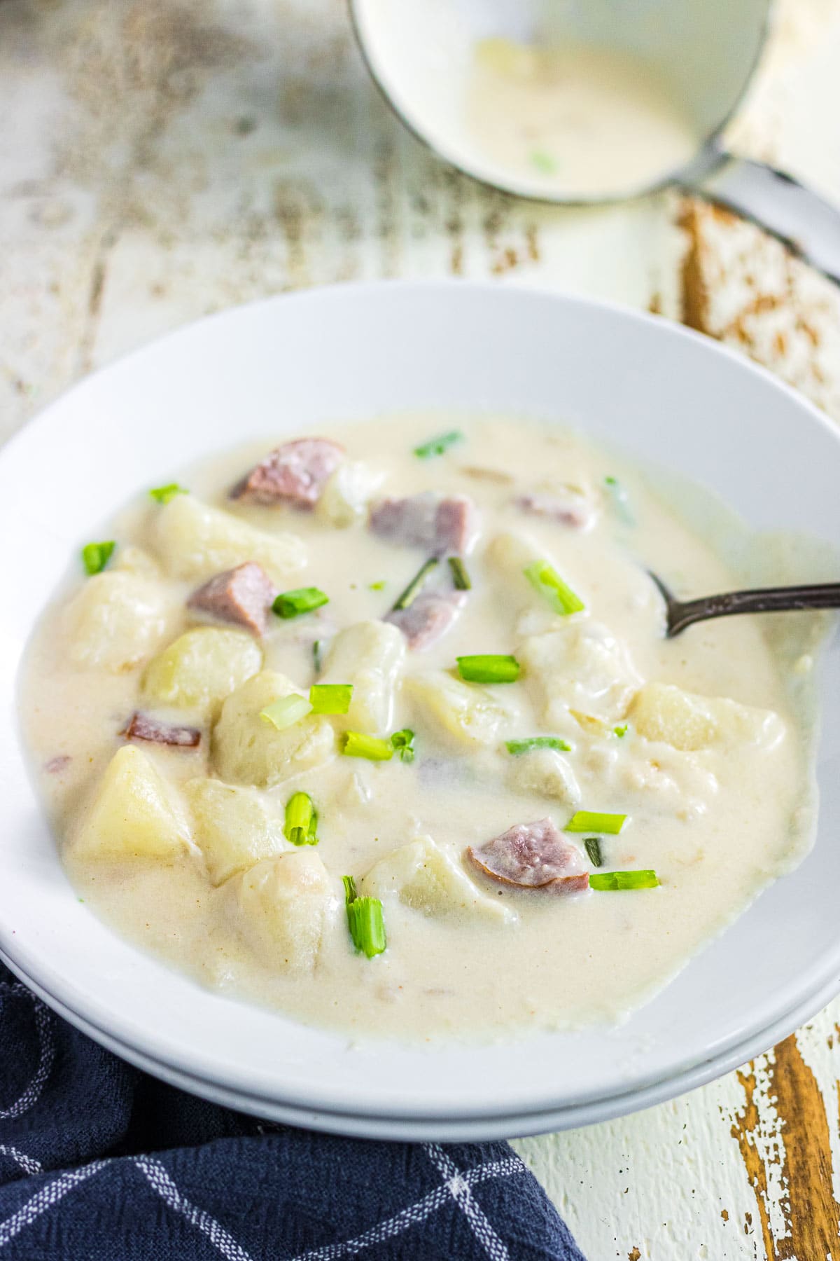 An up-close view of smoked sausage potato soup in a dinner bowl.