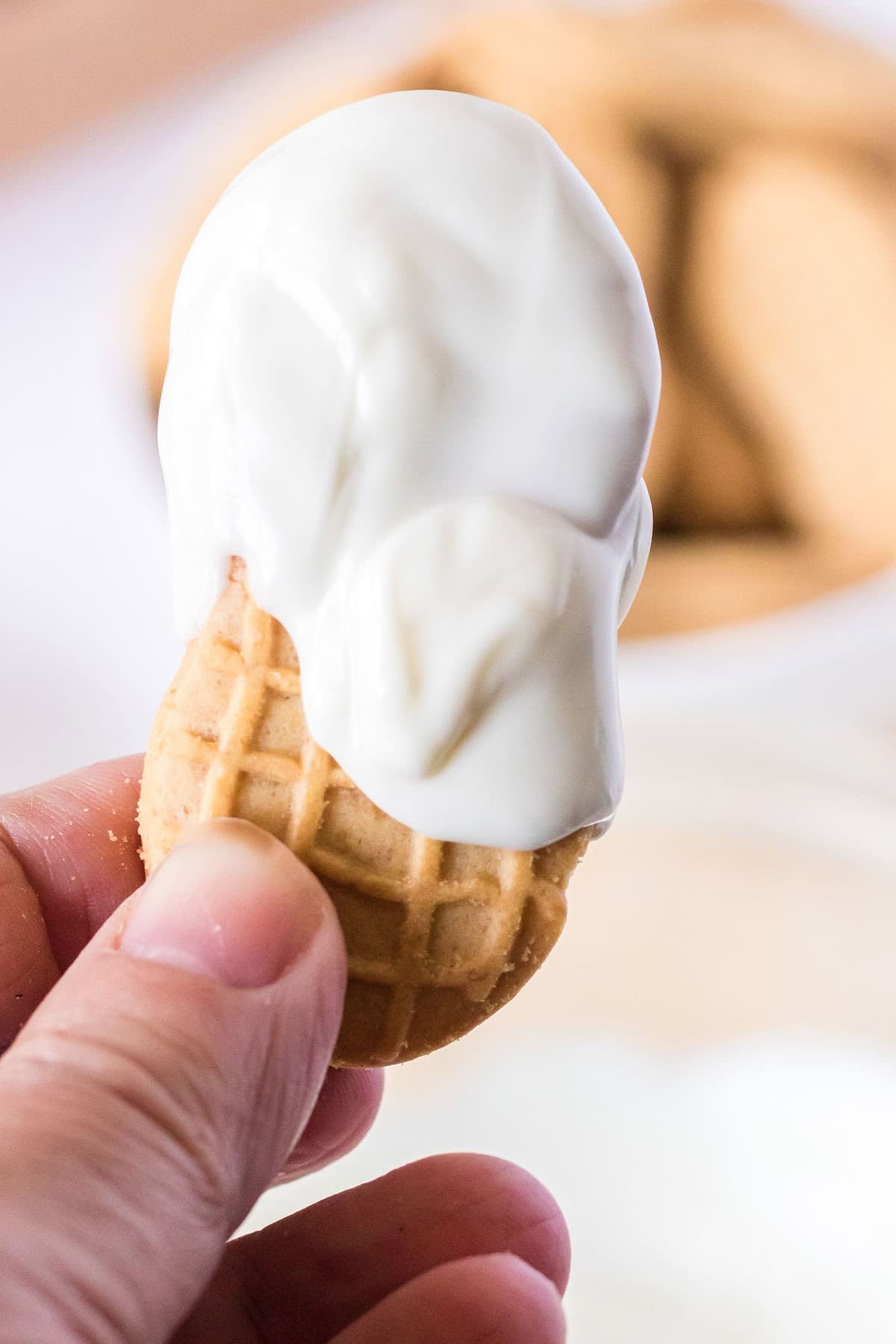 A cookie partially covered with white chocolate.