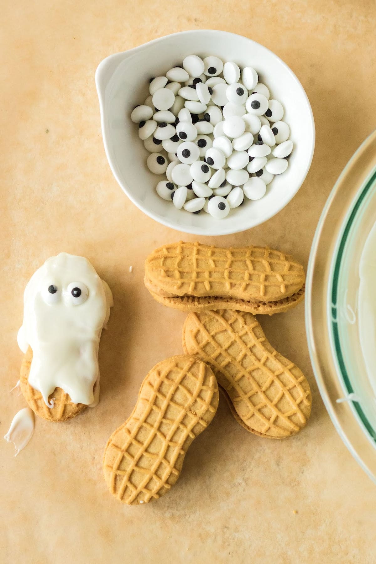 Candy eyes have been added to the white chocolate covered cookie.