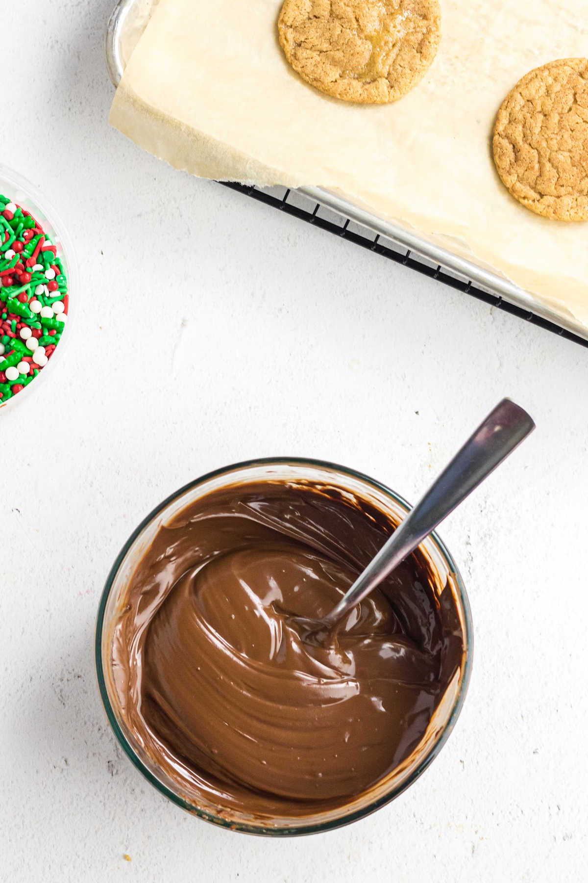 Melted chocolate with baked cookies ready to be dipped.