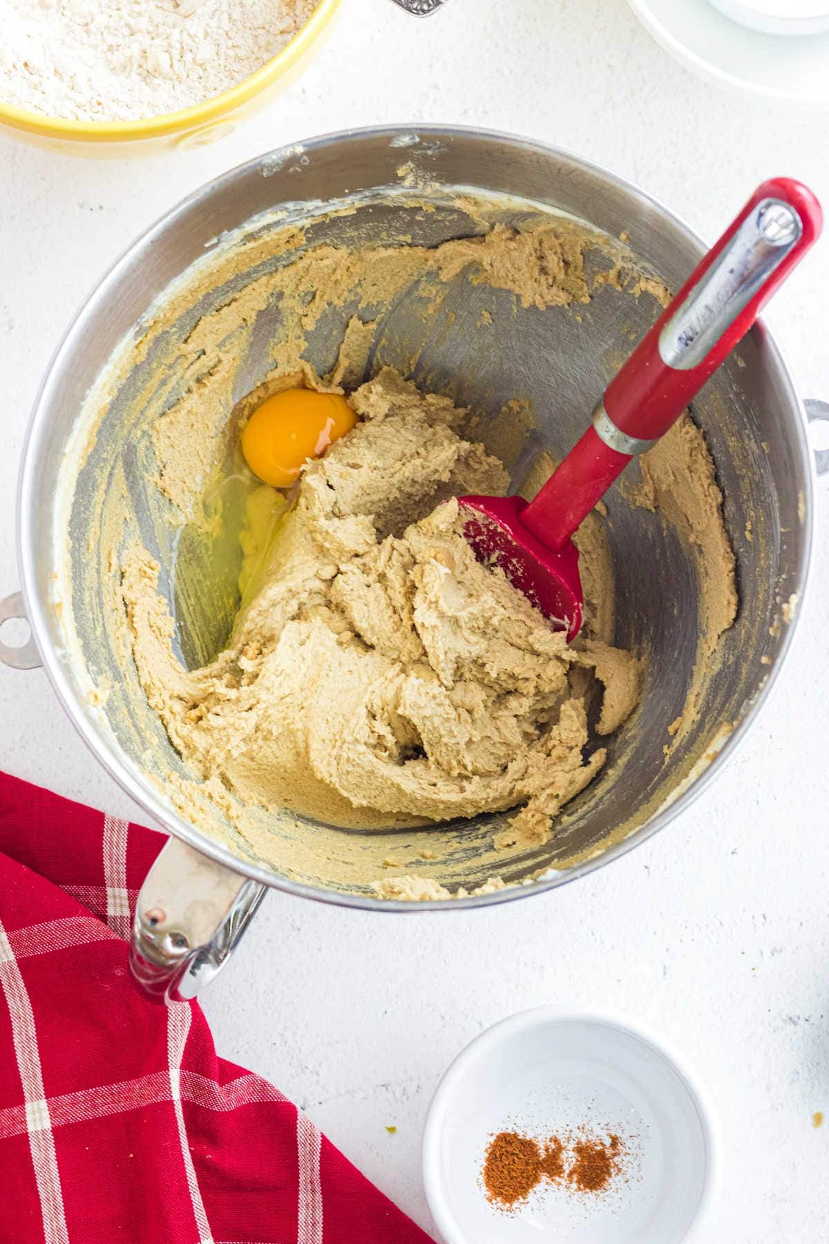 Butter and sugar being mixed with eggs.