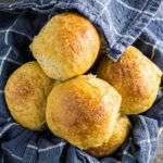 Overhead view of sweet potato dinner rolls with a title text overlay for Pinterest.