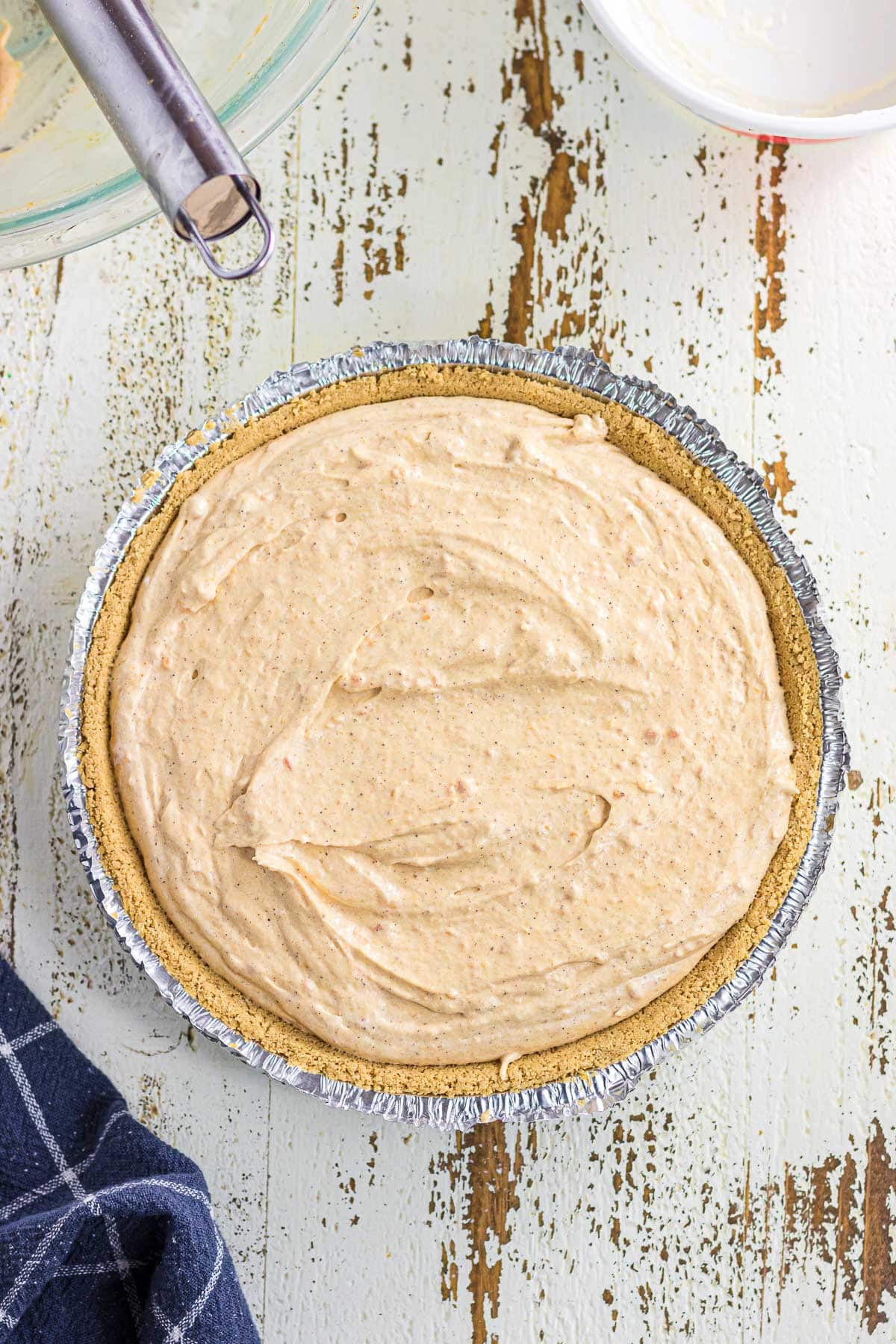 The sweet potato pie filling spooned into the prepared pie crust.