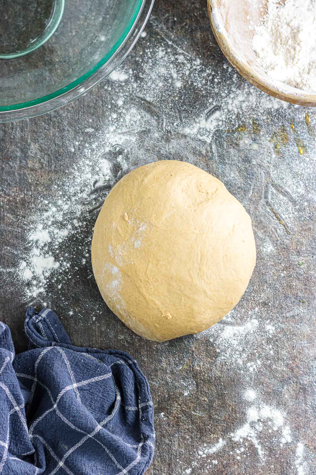 The dough formed into a ball on a floured surface.