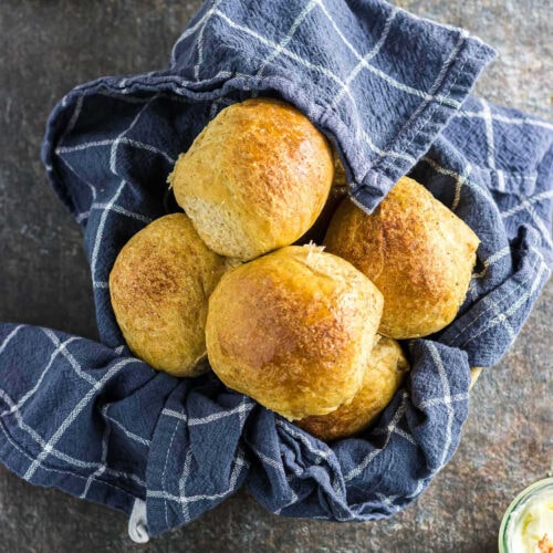 Overhead view of sweet potato dinner rolls in a bowl.