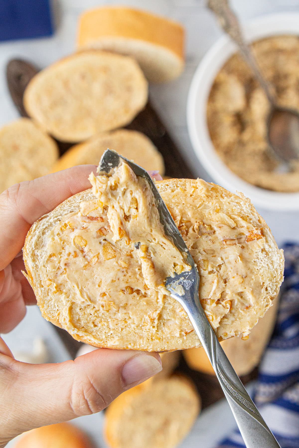 Spreading a slice of bread with the butter mixture.