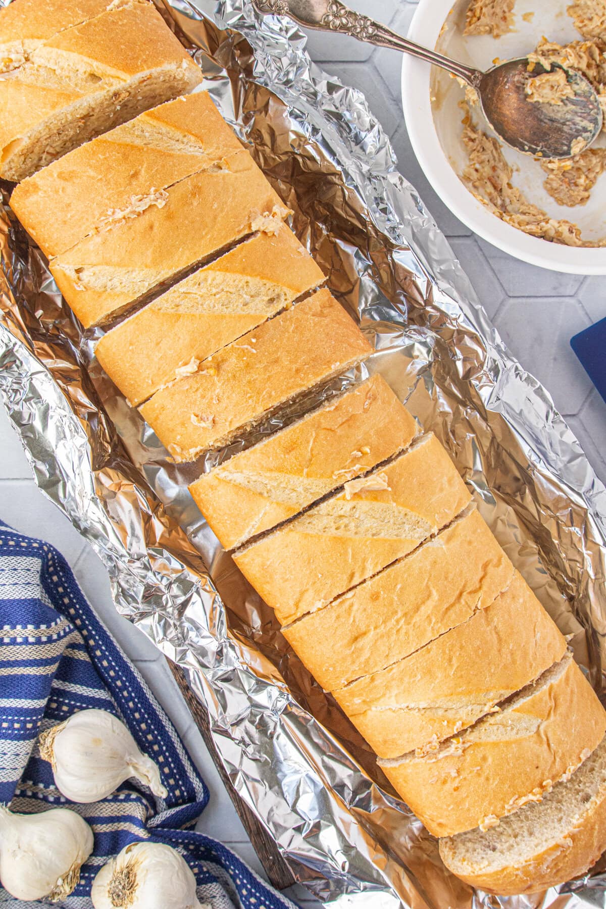 Buttered slices of French bread re-formed into a loaf and wrapped in foil.