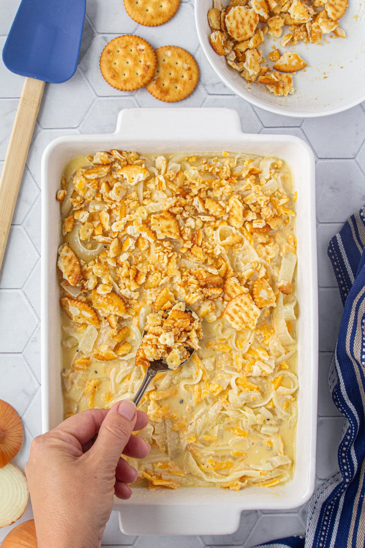 Topping the casserole with the buttered crackers.