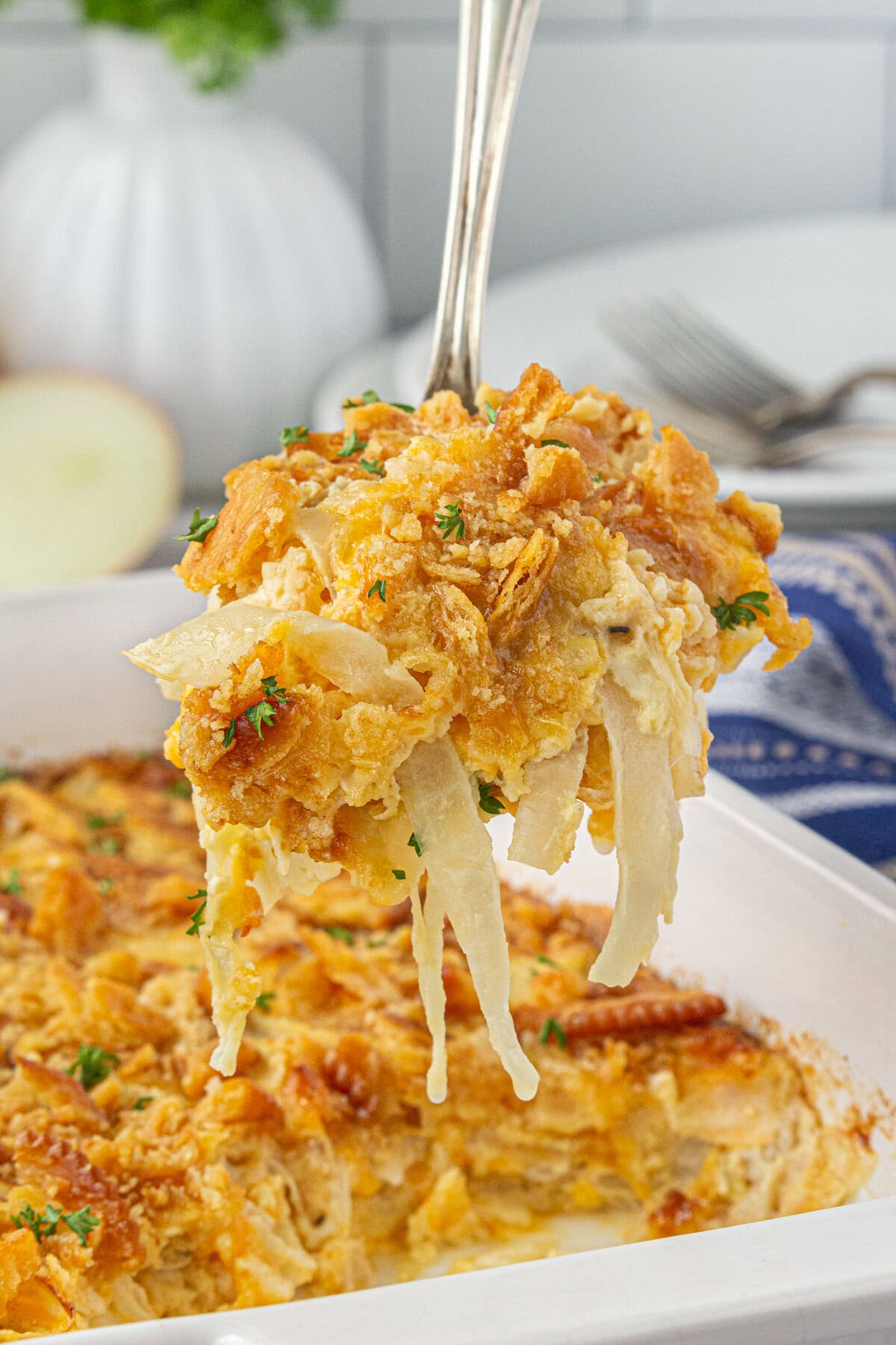 A scoop of Southern sweet onion casserole on a serving spoon.