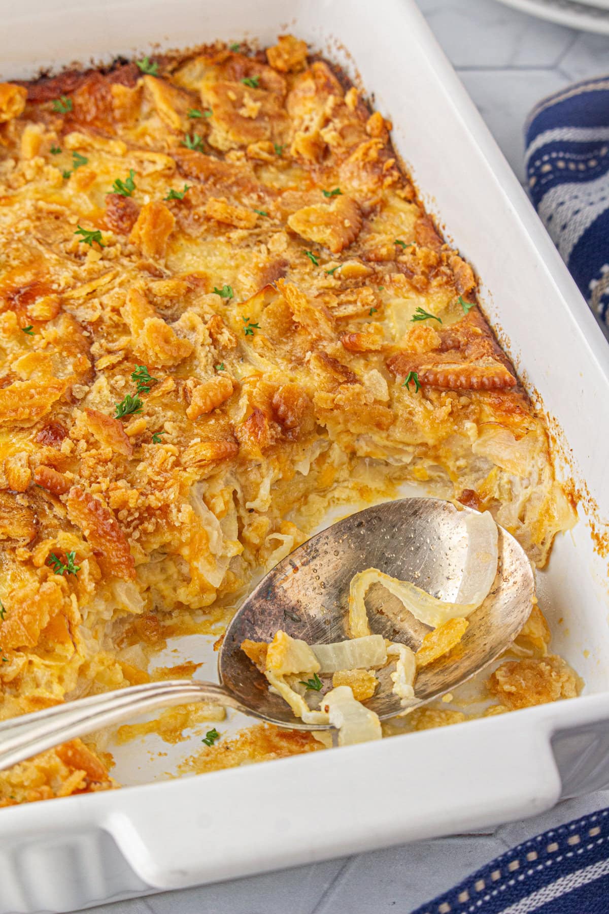 A scoop of Southern sweet onion casserole taken out of the dish.