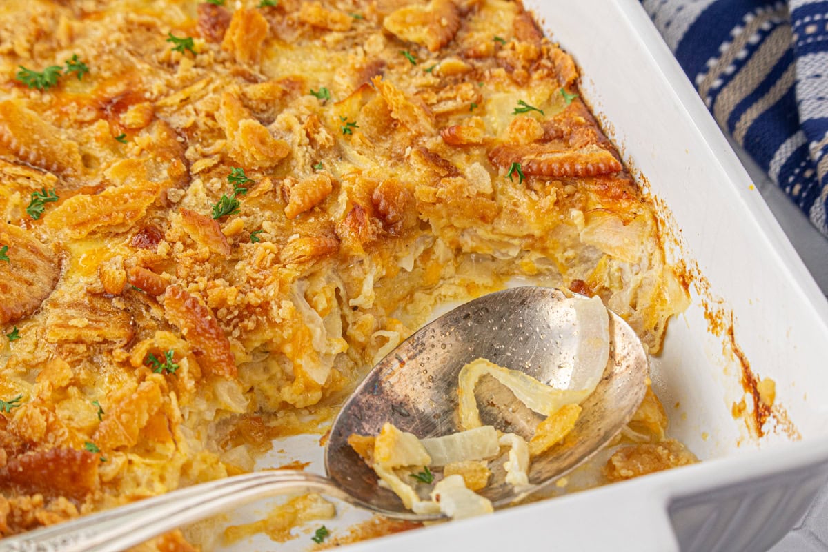 Closeup of the finished onion casserole in a white casserole dish.