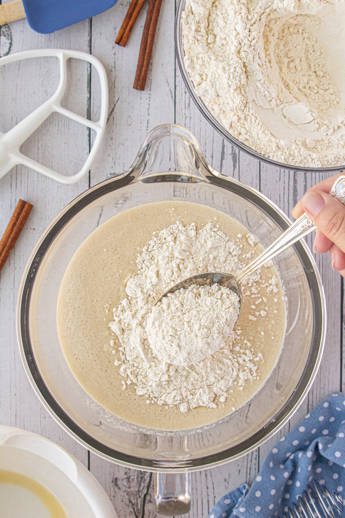 Flour being sprinkled over yeast.