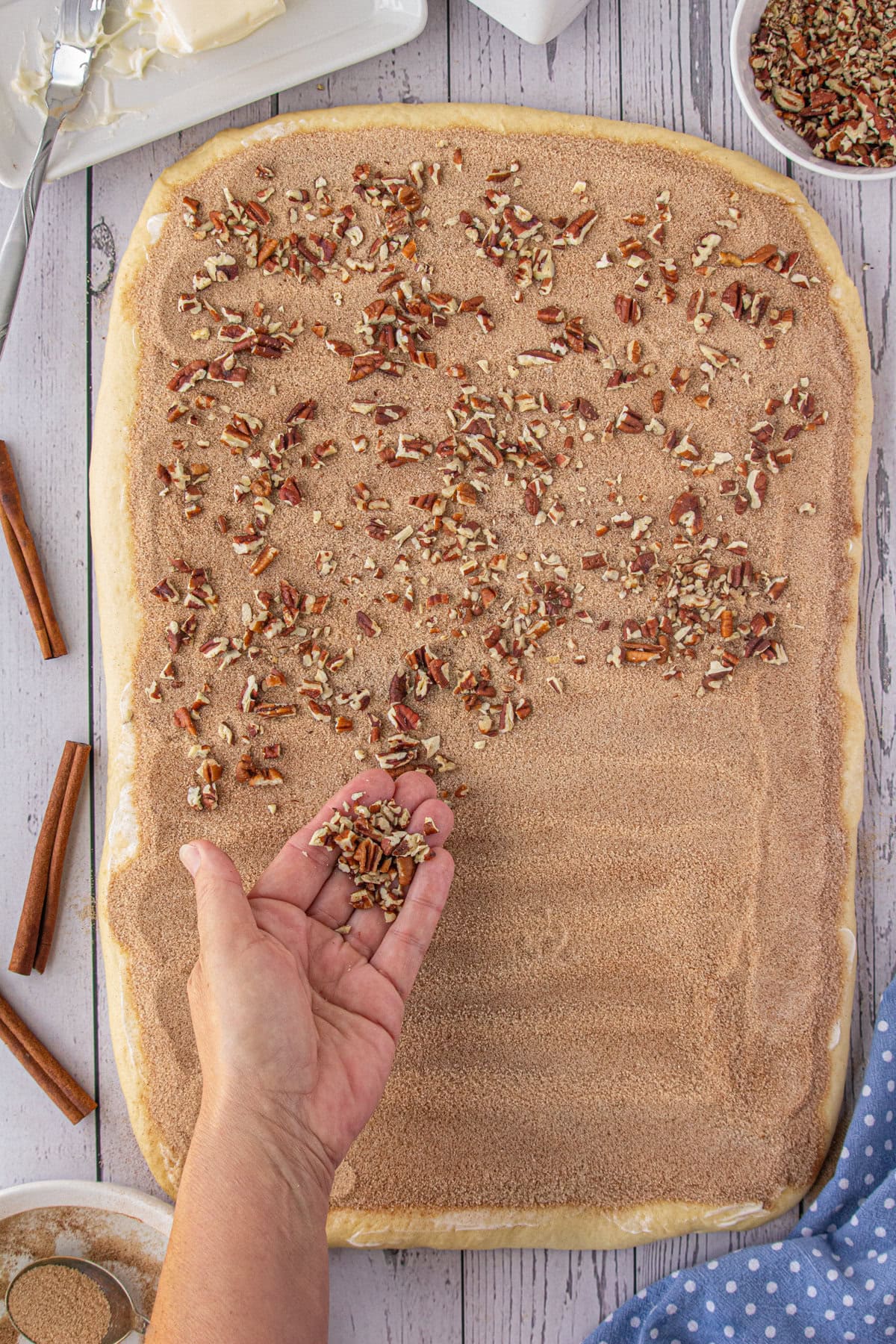 Pecans being added over the cinnamon.