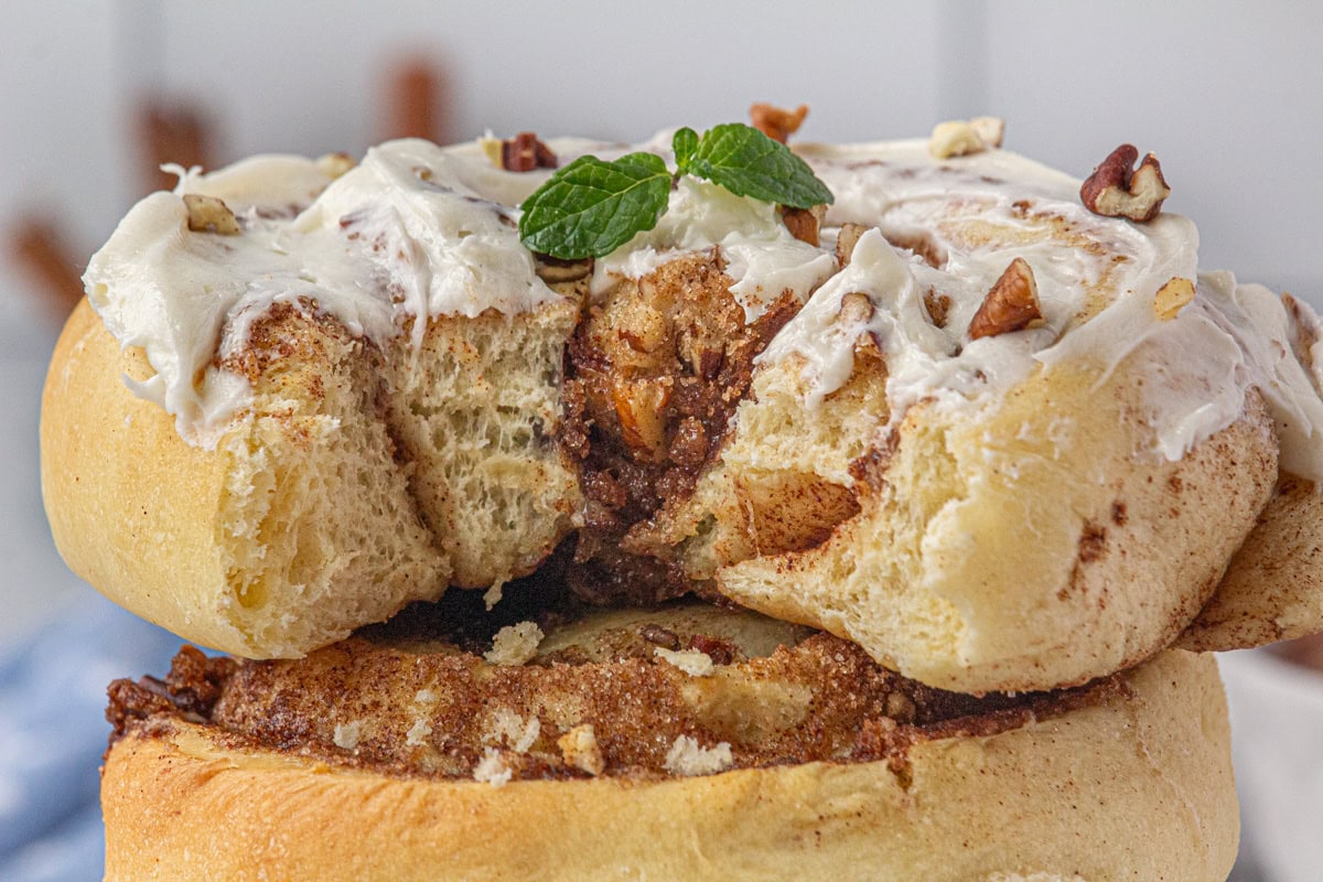 Closeup of a cinnamon roll with a bite removed.