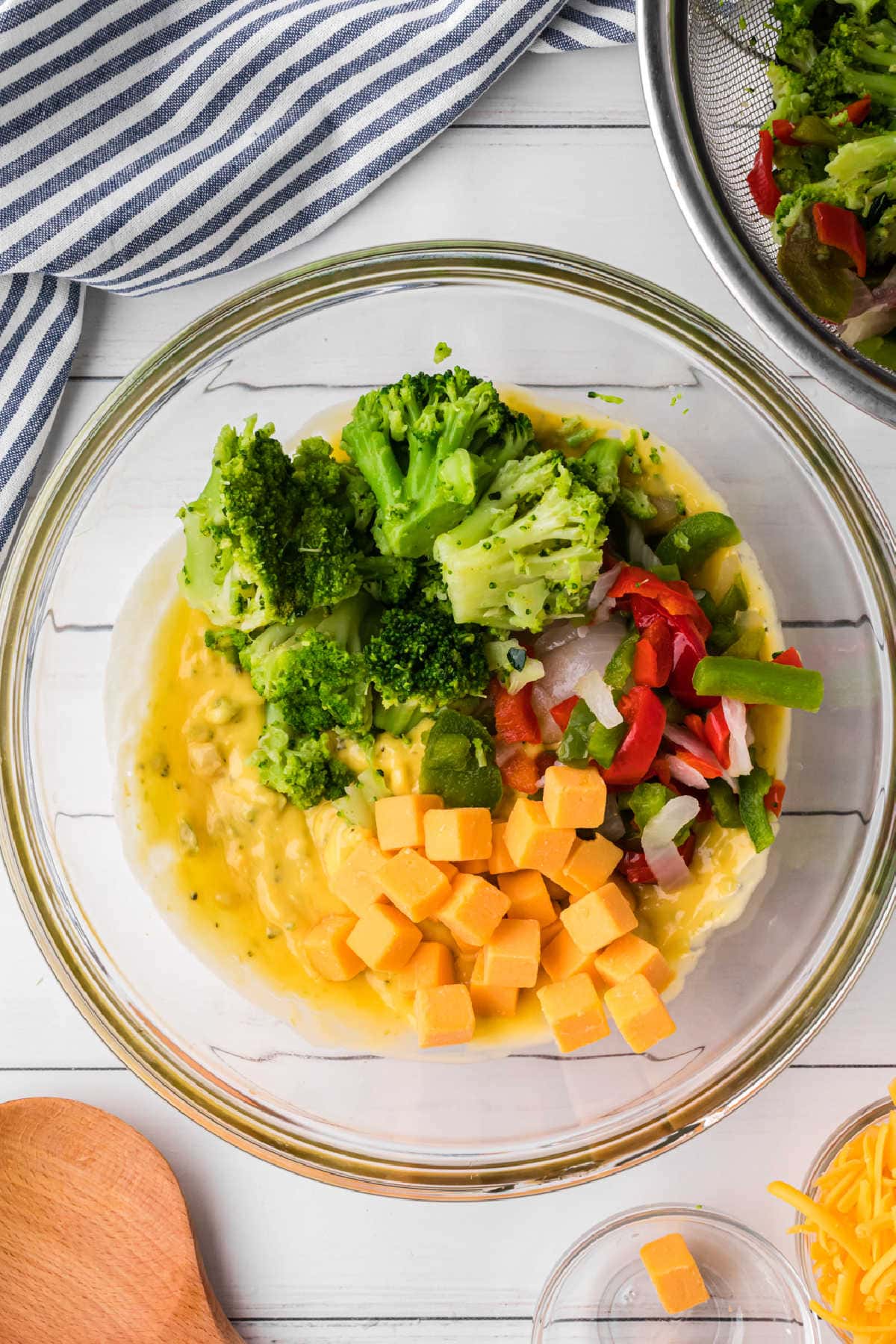 Soup, cheese, and vegetables have been combined in a separate bowl.