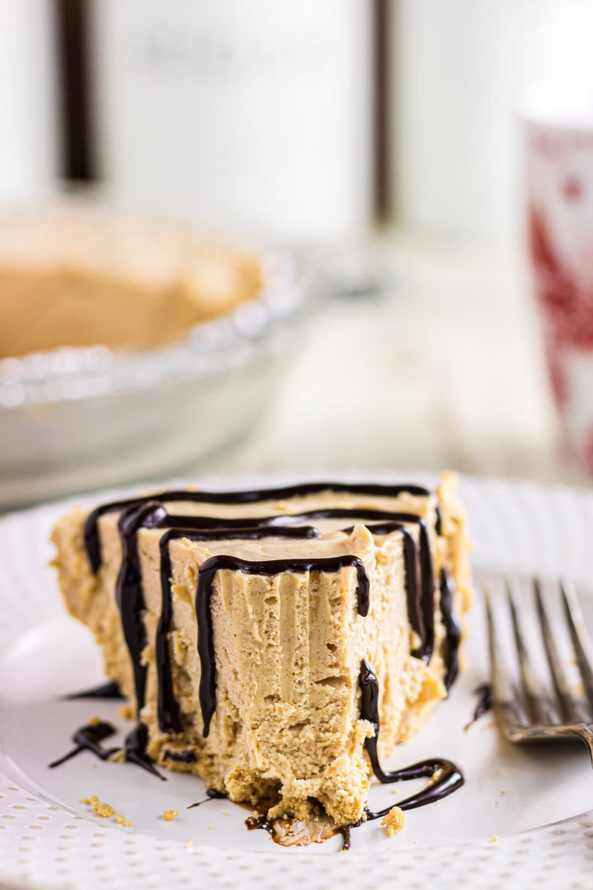 A slice of no-bake peanut butter icebox pie with one bite taken out.