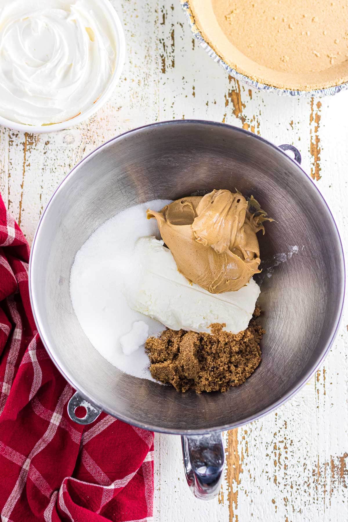 The peanut butter, brown sugar, white sugar, and cream cheese in a bowl.