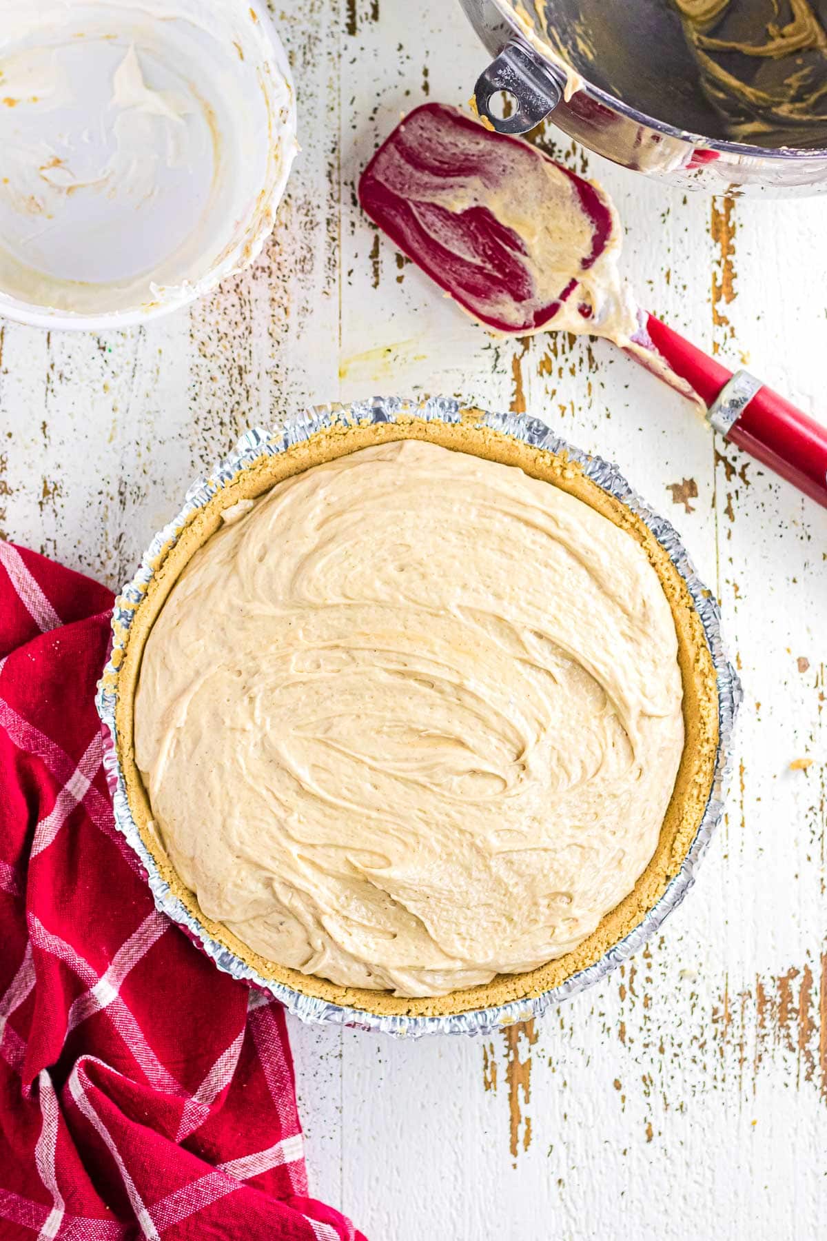 The peanut butter pie filling spread in the crumb crust.