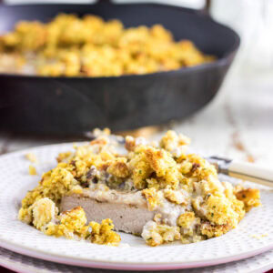 Pork chops and stuffing on a plate.