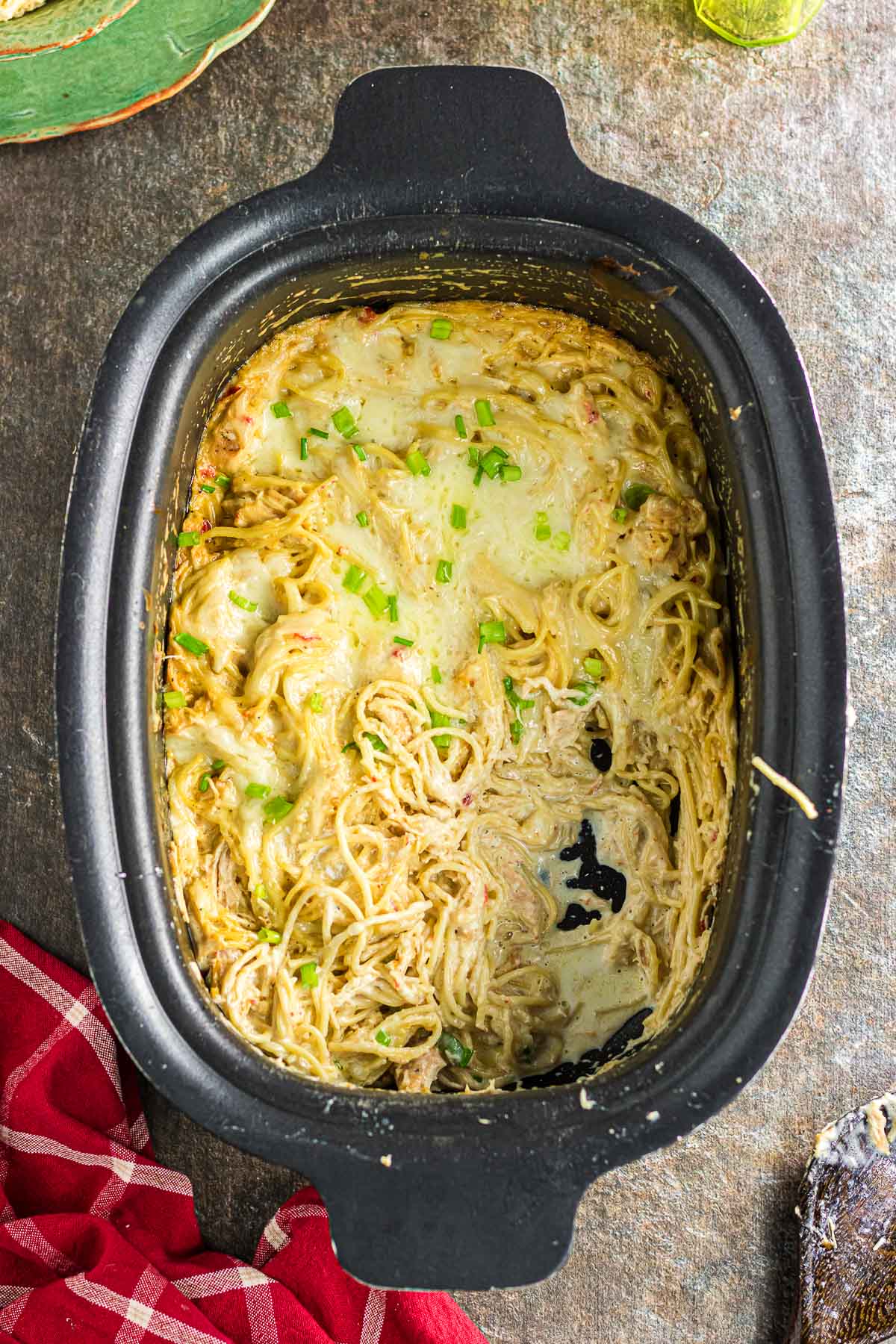 An overhead view of slow cooker chicken tetrazzini with a scoop taken out.