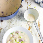 Overhead view of a bowl of smoked sausage potato soup with title text overlay for Pinterest.