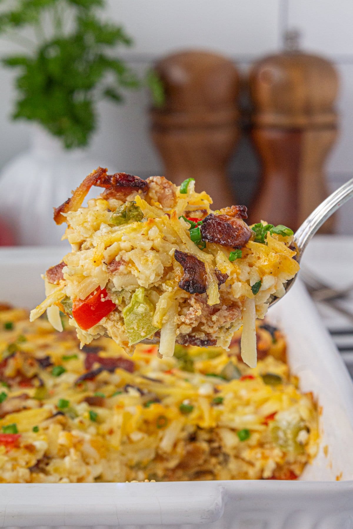 An up-close view of a spoonful of Amish breakfast casserole.