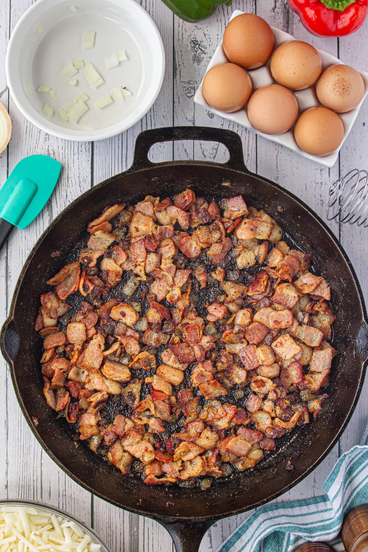 Cooking the bacon and onions in a skillet.