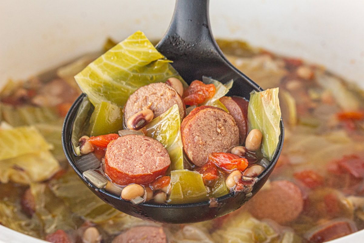 A ladleful of soup being served.