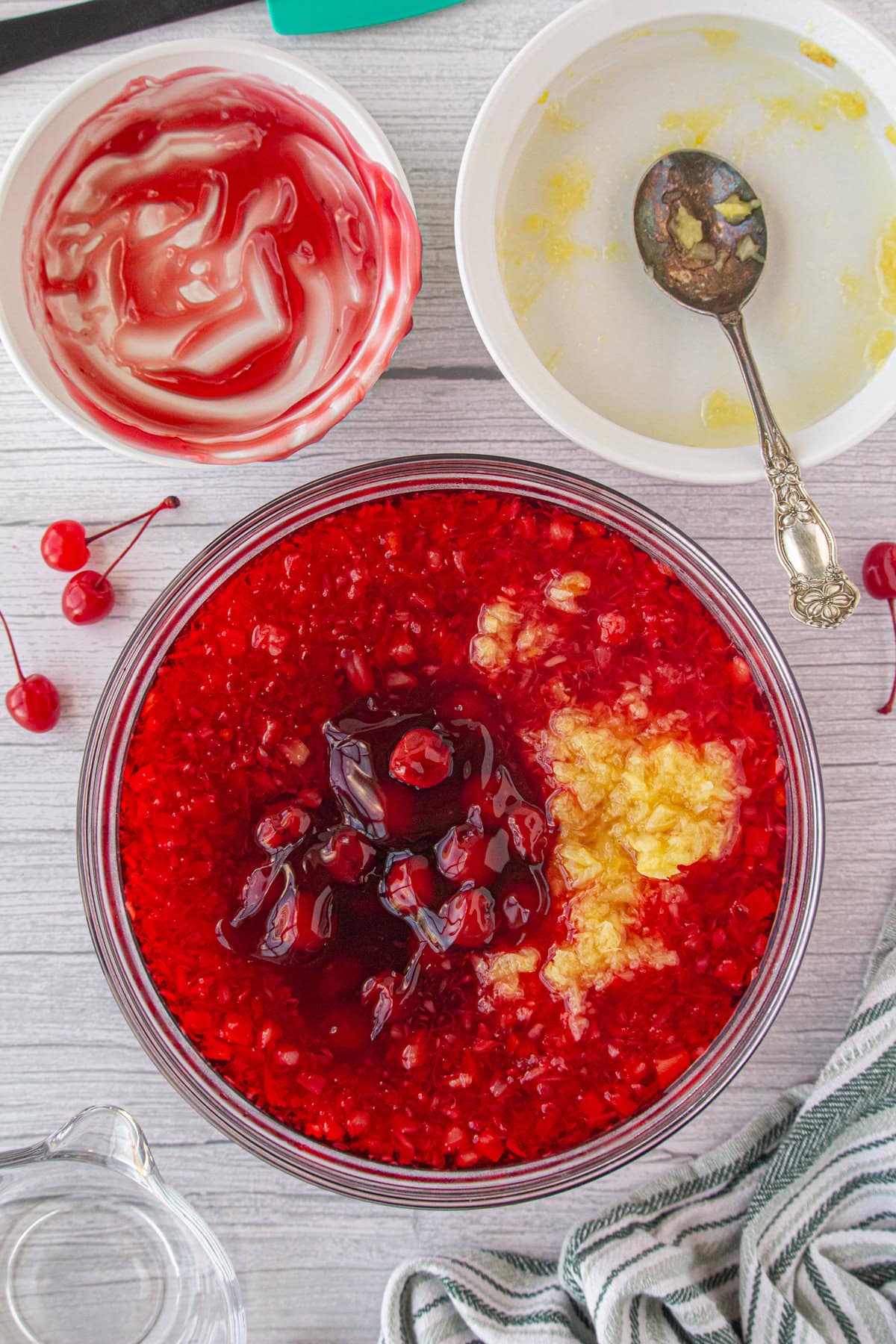 Combining the boiling water, Jello, pineapple, and cherry pie filling.