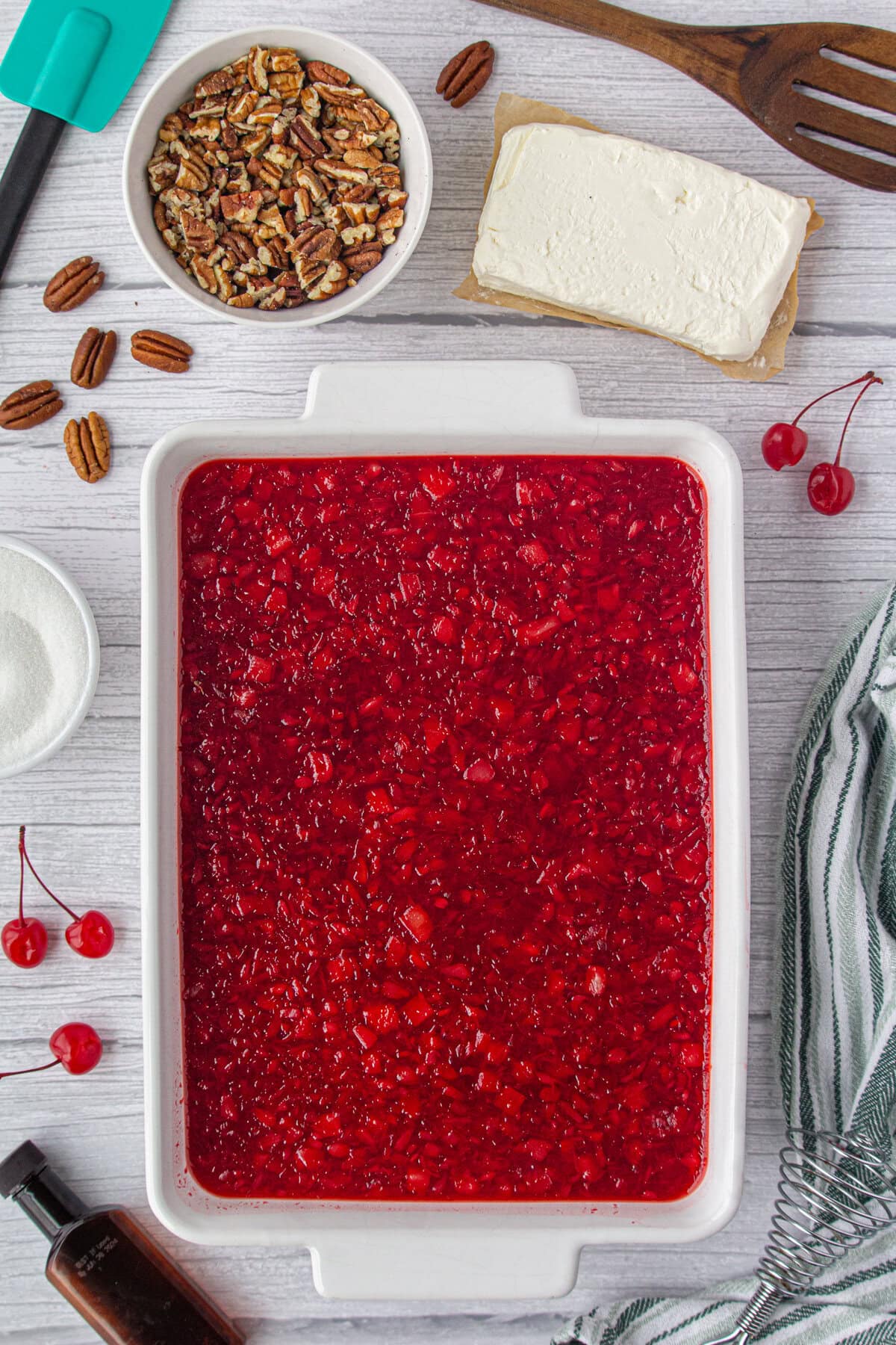 The cherry pie and Jello mixture spread into a casserole dish.